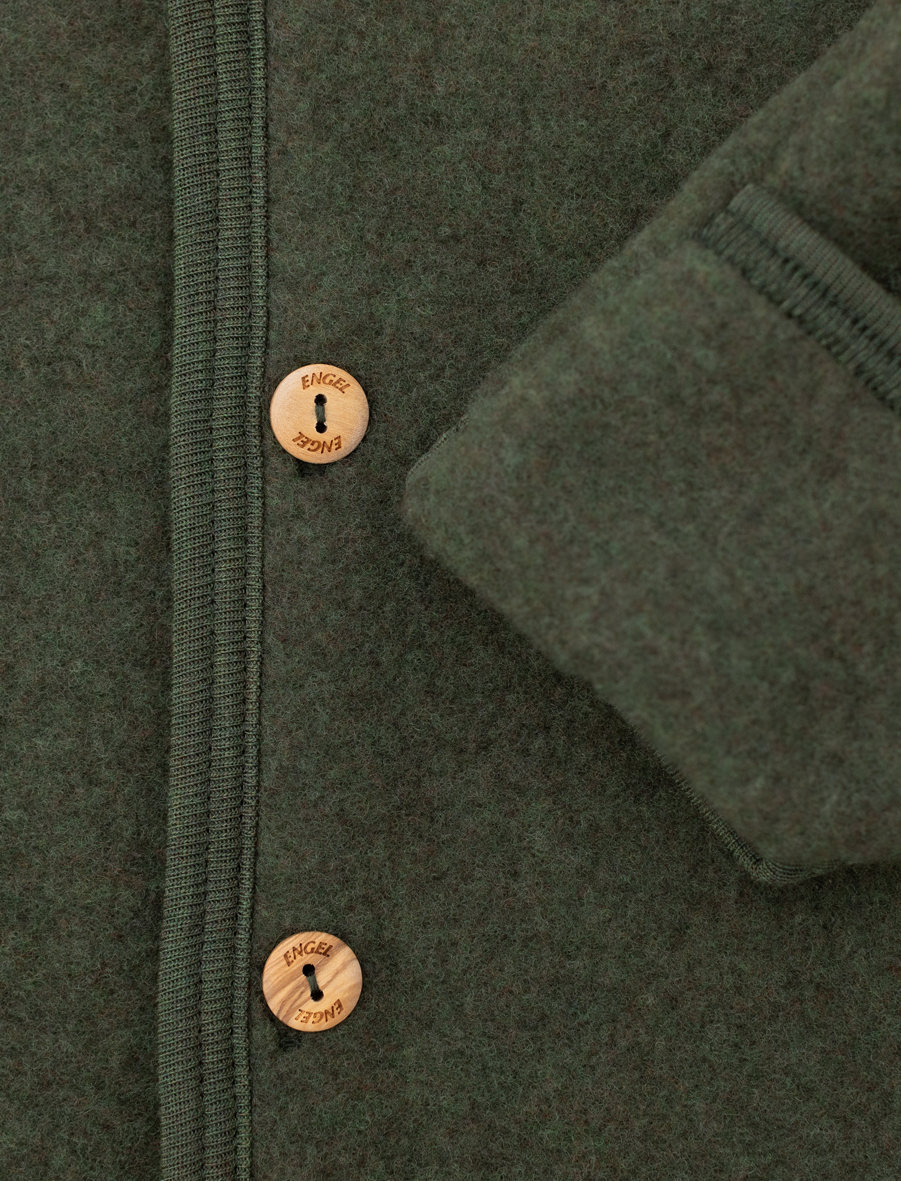 Close-up of a dark olive green wool jacket with a buttoned front and a folded cuff showing the ribbed lining.