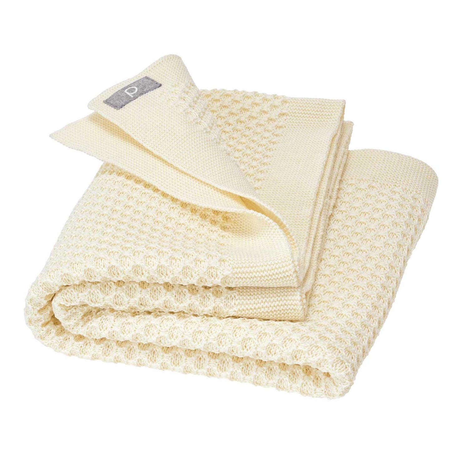 Folded beige textured blanket on a white background
