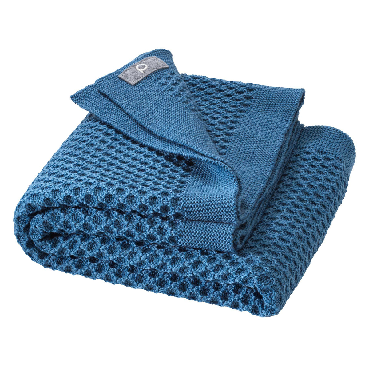 Folded blue textured blanket on a white background