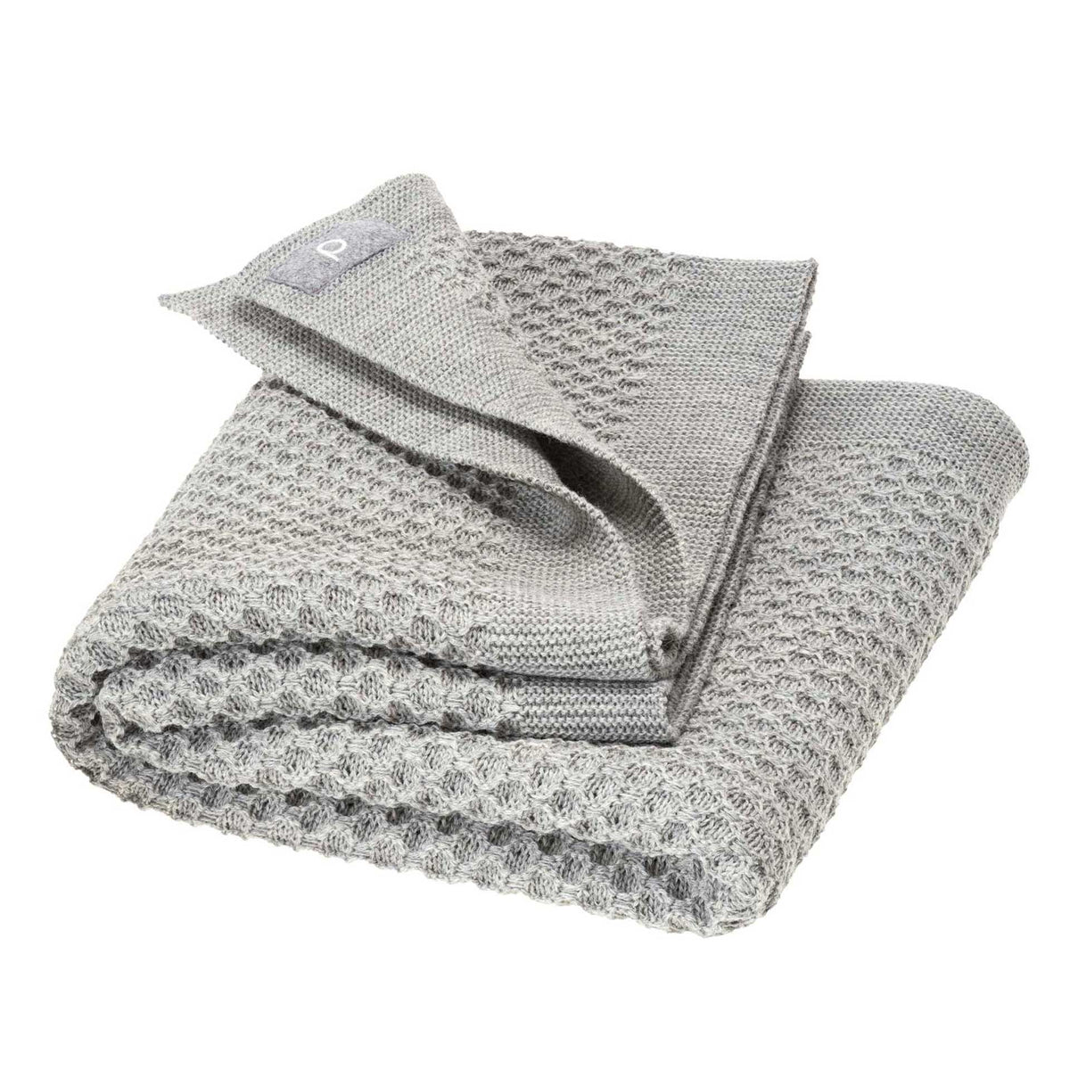 Folded textured gray blanket on a white background