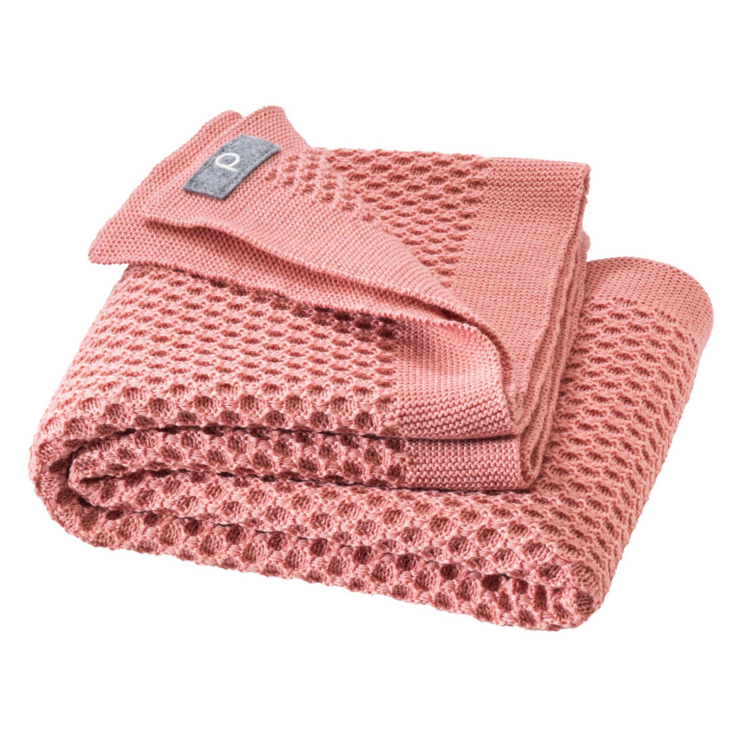 Folded pink textured blanket on a white background