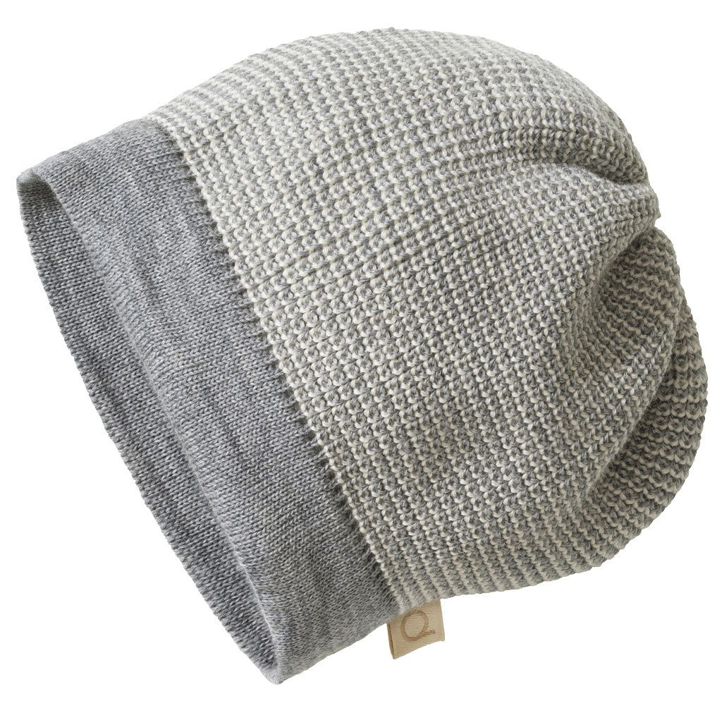 Grey knit beanie with a tag on a white background
